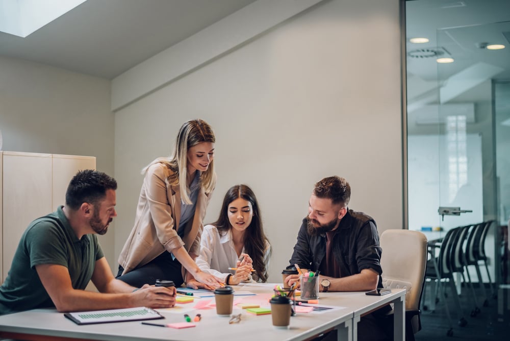 Group of colleagues talking about projects during a meeting in a boardroom